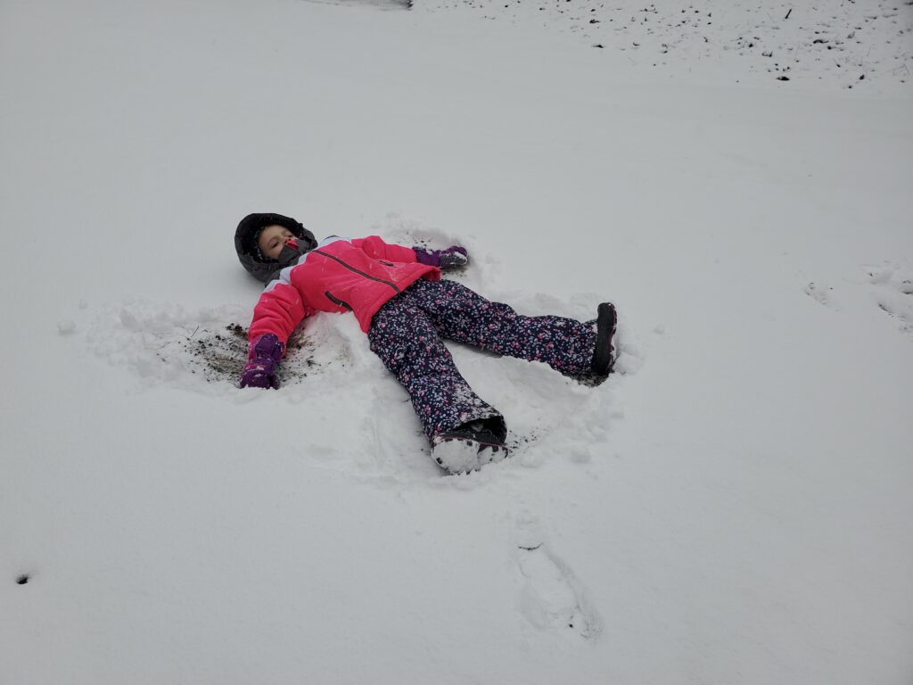 Elise in the snow making snow angels.